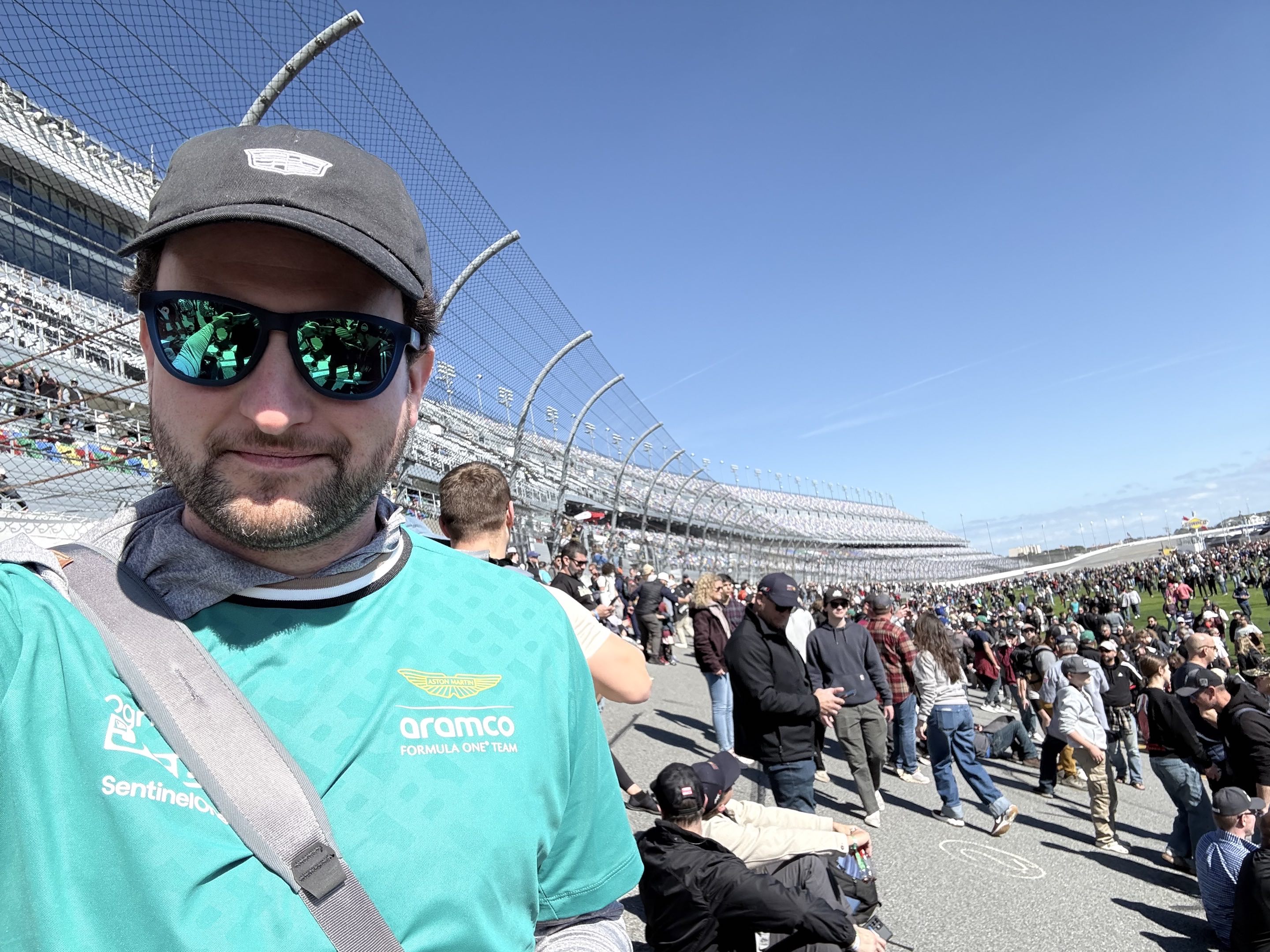 A man in sunglasses standing on an extremely sloped race track